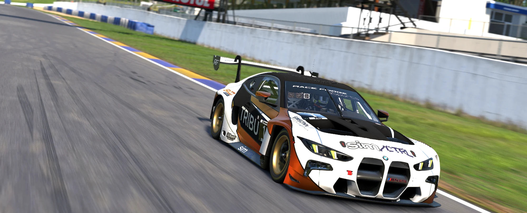 Race Forge BMW M4 GT3 in orange, white and black on track at Road Atlanta.